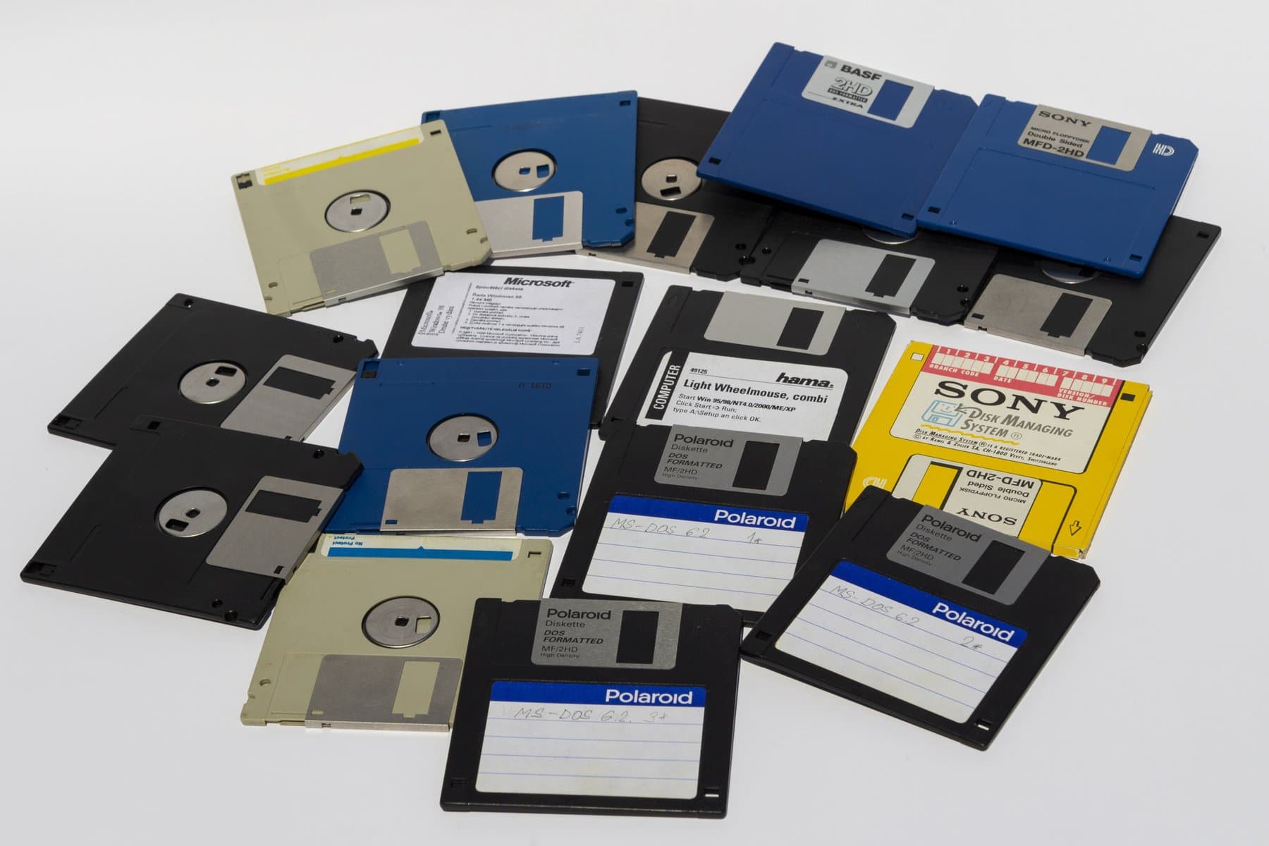 Assorted 3.5-inch floppy disks with handwritten and printed labels