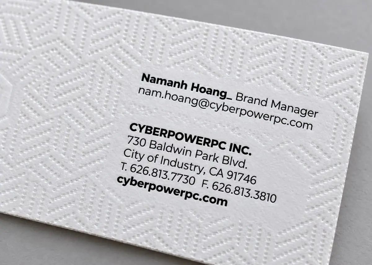 Close-up showing the tactile dotted geometry and paper texture of the CyberPowerPC business card.