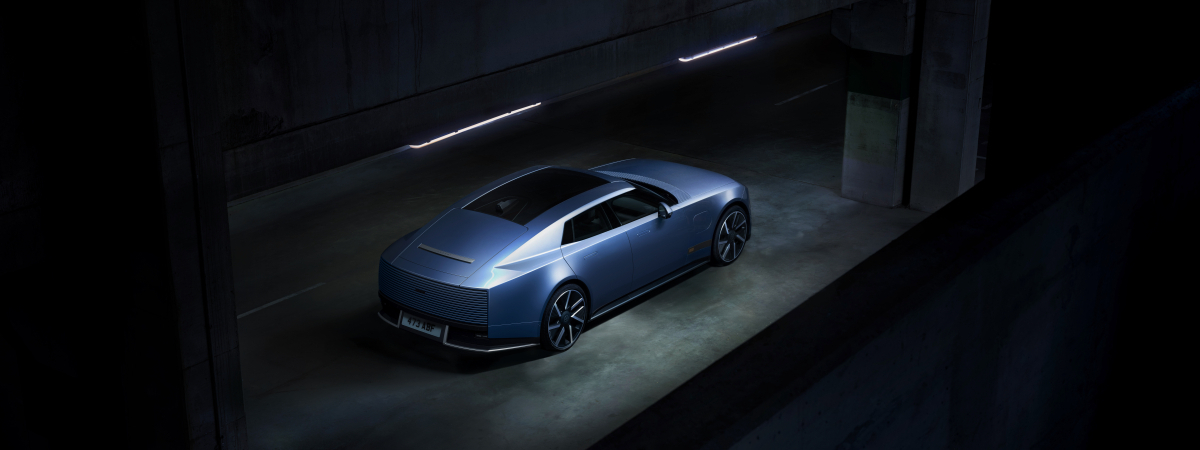Blue Jaguar Type 01 viewed from above, showing its long hood, low roof, and four-door body.